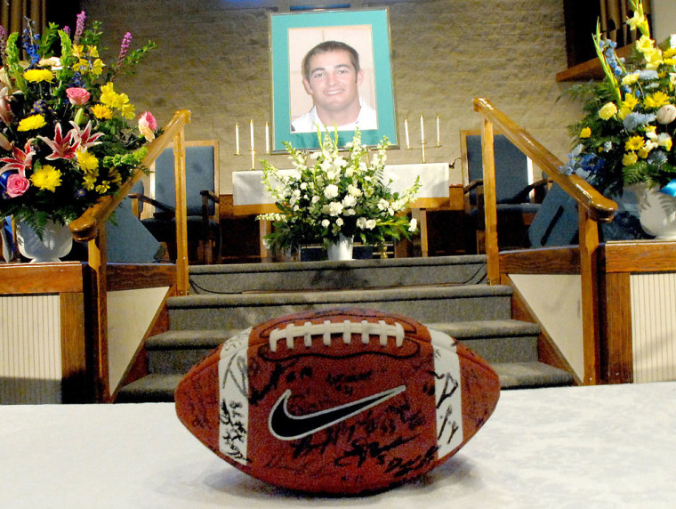 William Bleakley's picture along with and autographed football from the University of South Florida Football team was on display Saturday March 7, 2009 during a memorial service for Bleakley in Crystal River, Fla. Several hundred people gathered at a Methodist church in Crystal River, a rural community north of Tampa, on Saturday afternoon to remember William Bleakley, a former University of South Florida player aboard the boat which overturned off Florida's west coast.  (AP Photo/Dave Sigler, Pool)